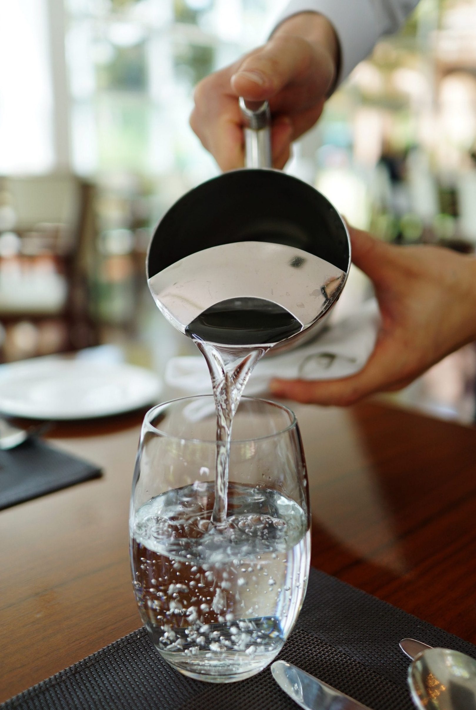 Pouring water into a glass