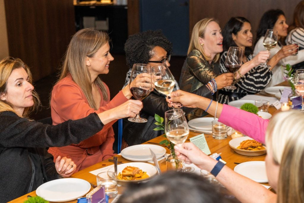 Women sitting around a dinner table_Elektra Health