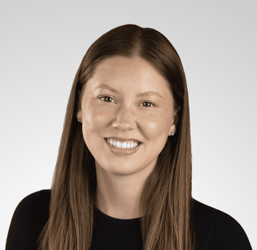 young woman with straight red-brown hair and a black long-sleeve shirt