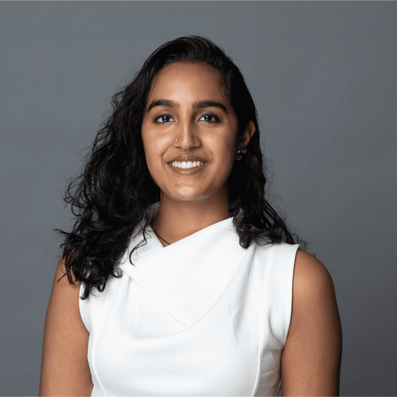 Young woman with dark hair and a white top